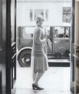 A cloche hat, jersey knit drop-waisted dress and low-heeled T-bar shoes were conventional day wear.